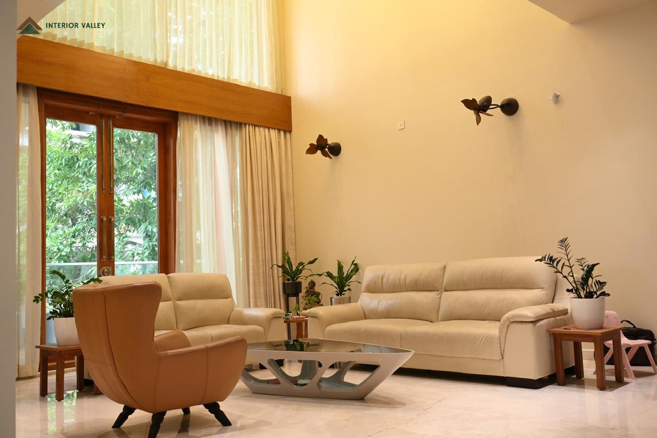 Living room with layered seating and full-height curtains