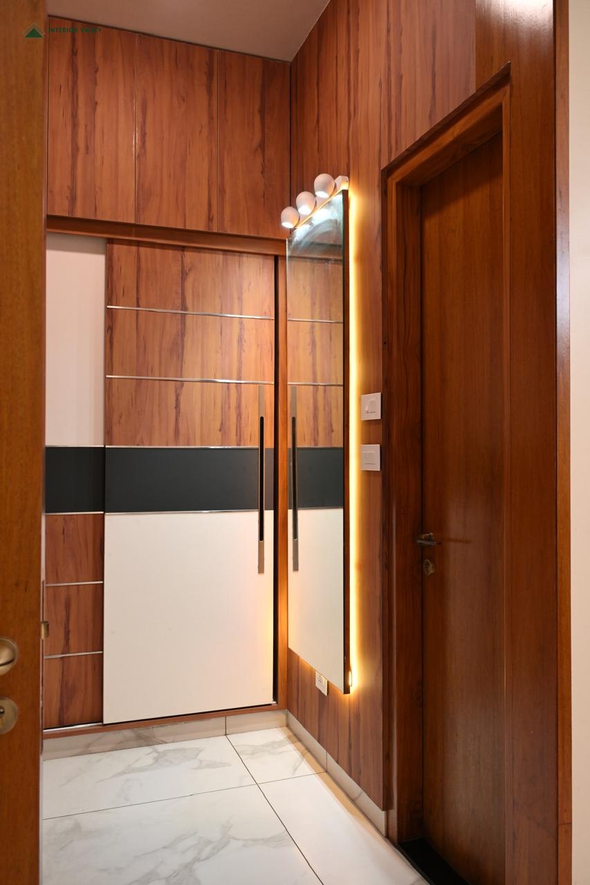 Foyer with wood panelling and a vertical light feature