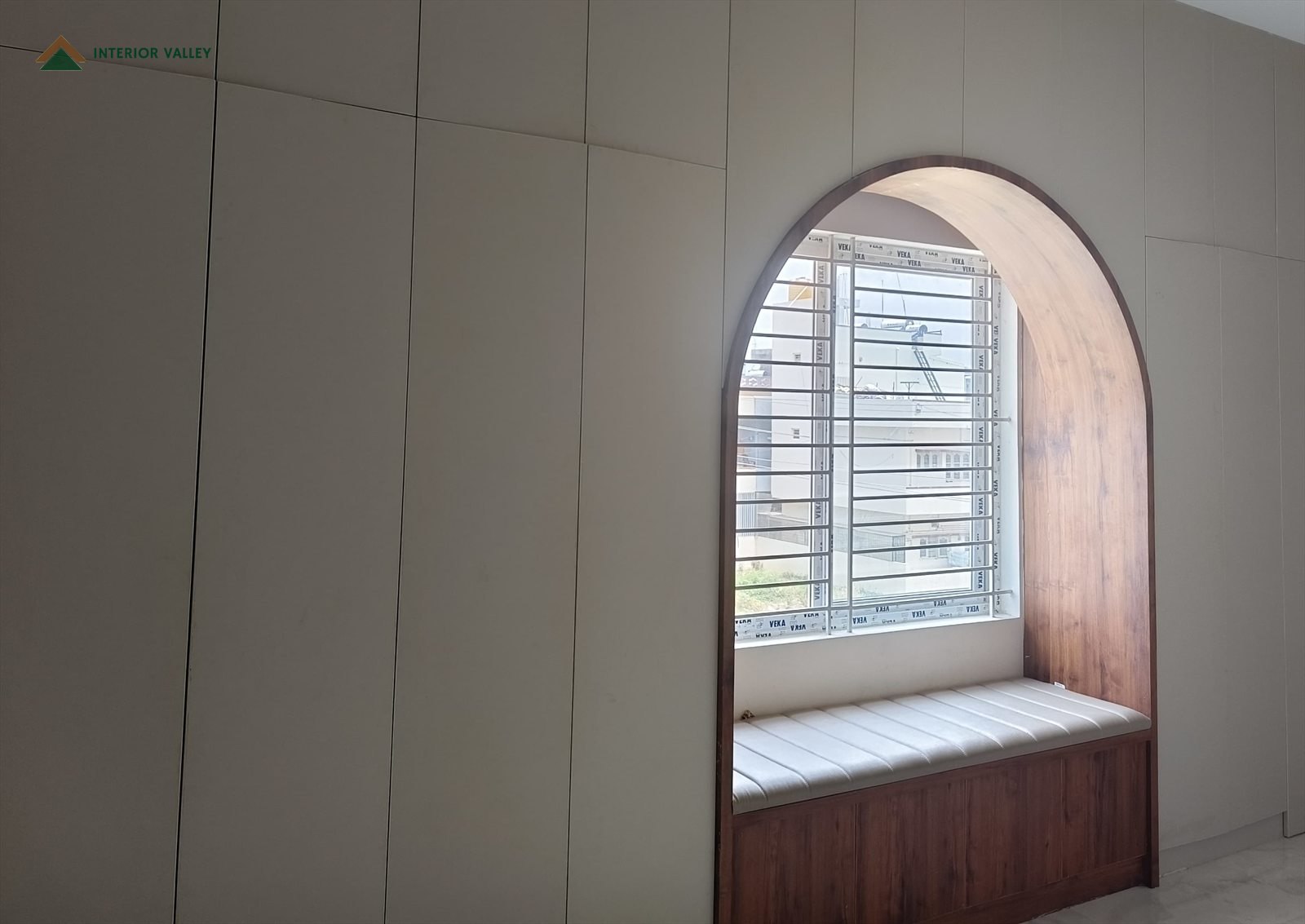 Arched window seat with a timber surround and an upholstered bench