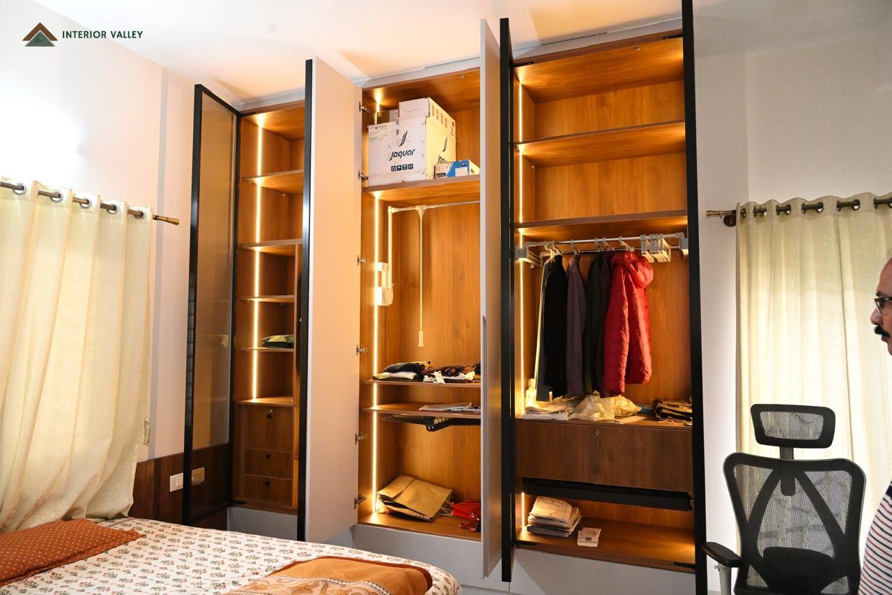 Wardrobe interior with lit shelving, drawers and hanging space