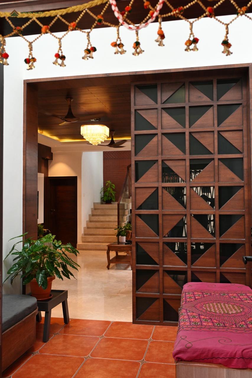 Carved wooden jaali screen dividing the entrance from the living area