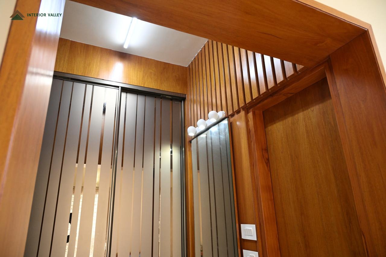 Corridor with fluted wood panelling and recessed lighting