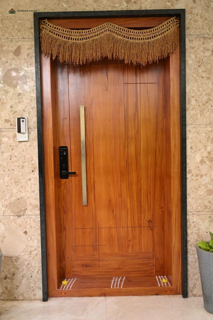 Teak main door with a slim vertical handle