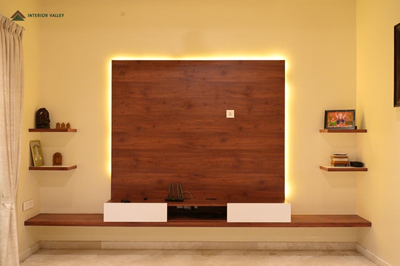 Living room wall with a backlit wood television panel