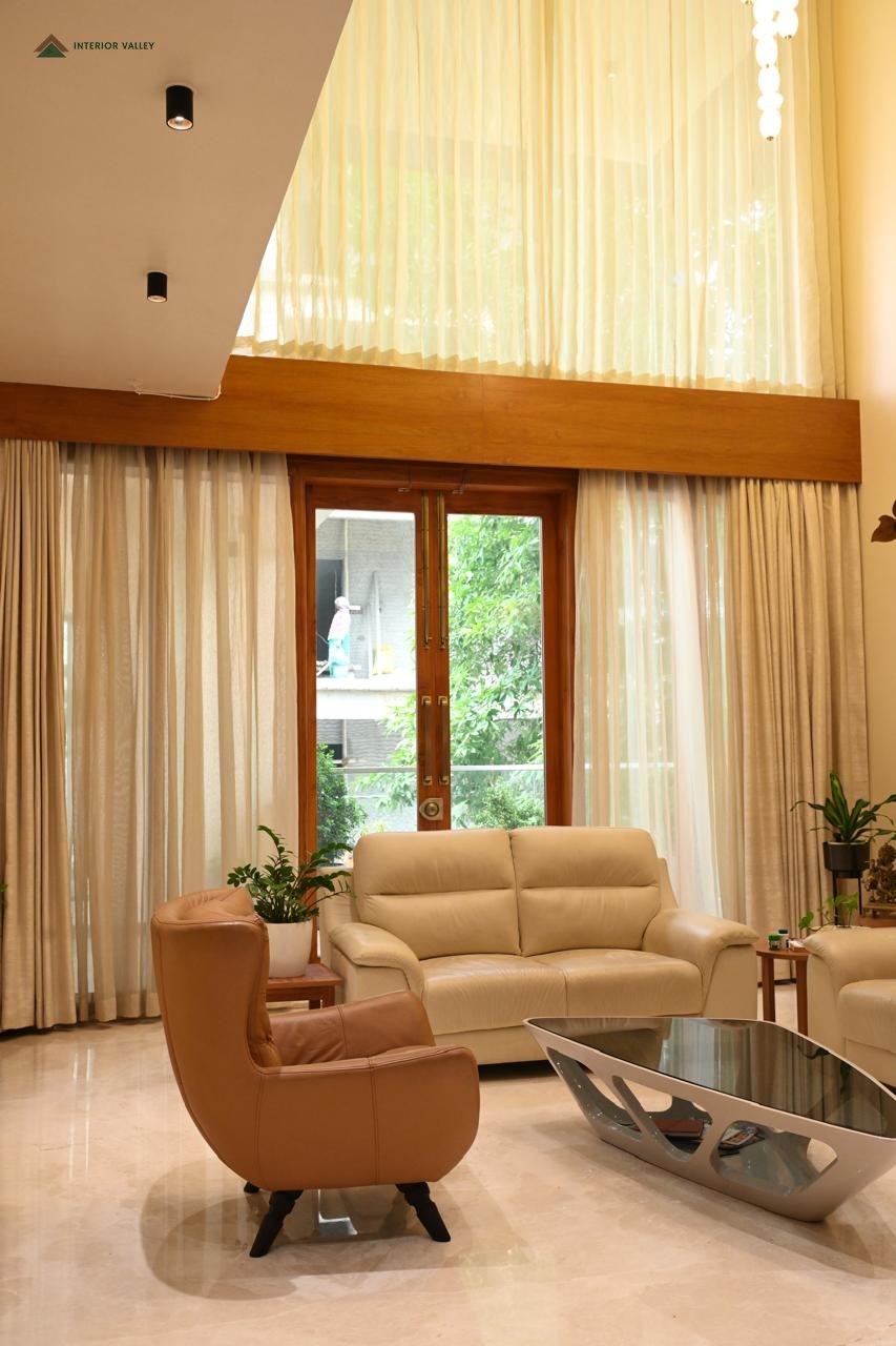 Living room seating beside full-height windows