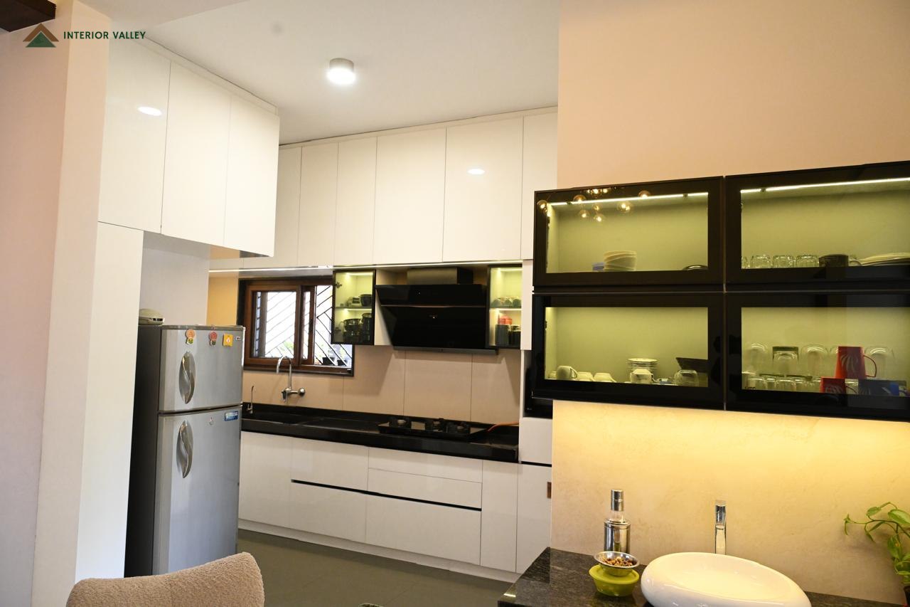 Modular kitchen in white and black with lit display cabinets