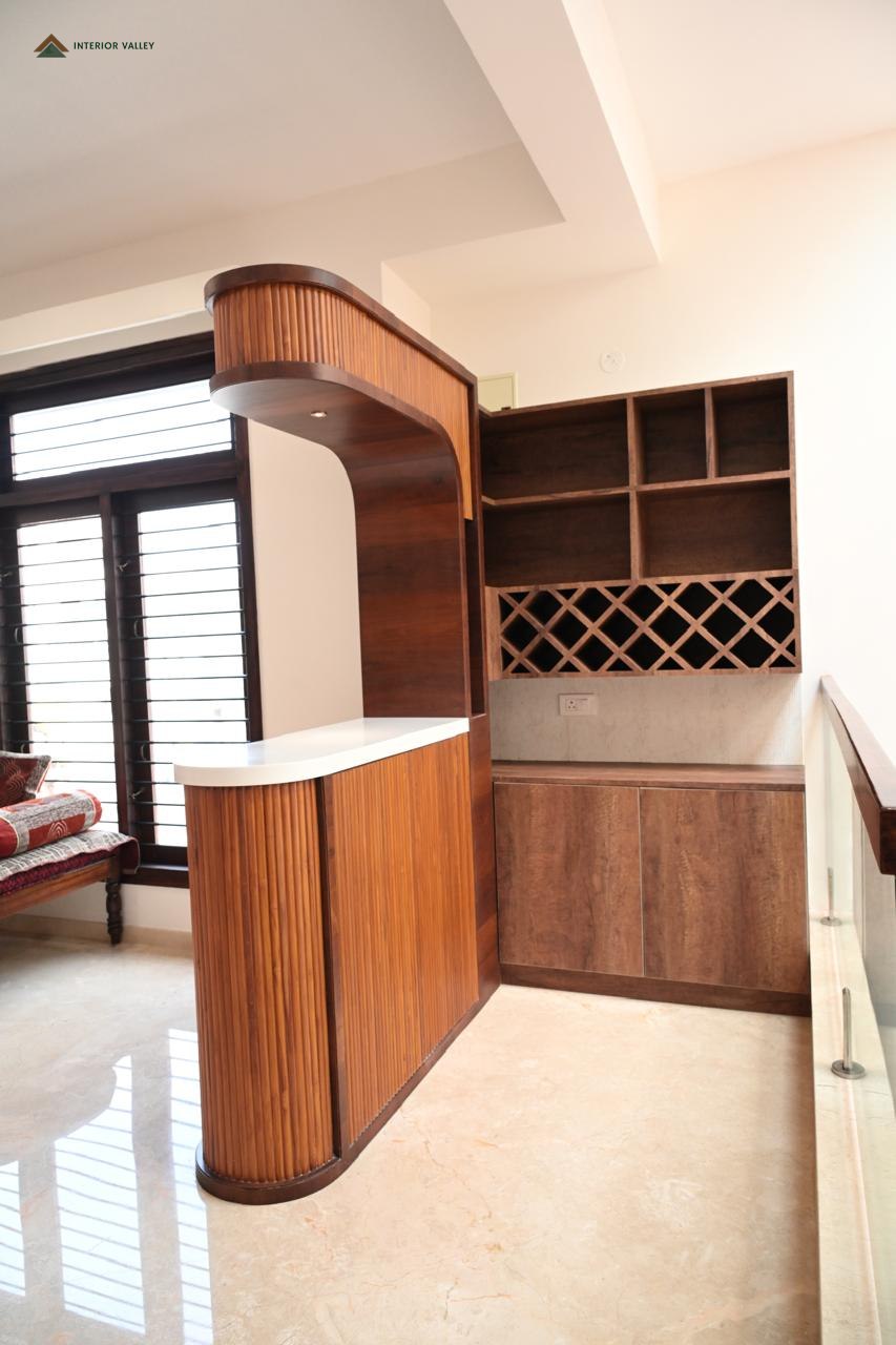 Curved wood bar and crockery unit with a wine rack