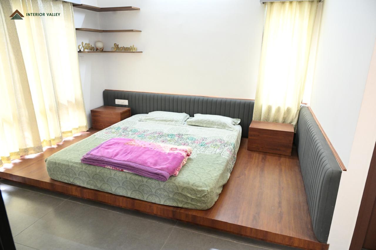 Bedroom with a platform bed and a long upholstered headboard