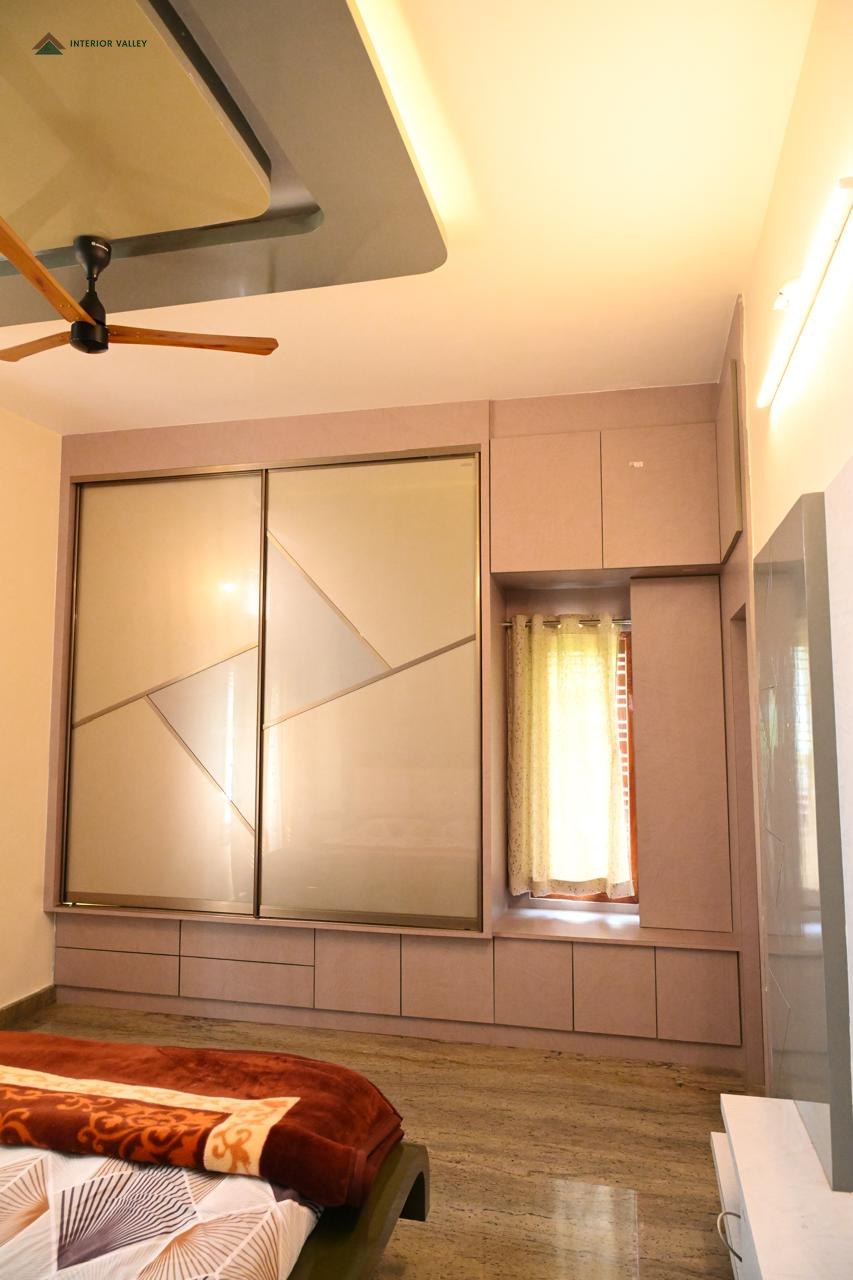 Bedroom with a full-width sliding wardrobe