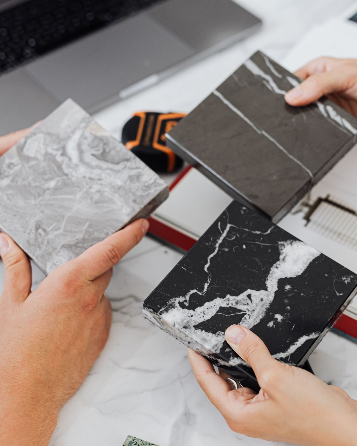 Stone and surface samples being compared over a drawing