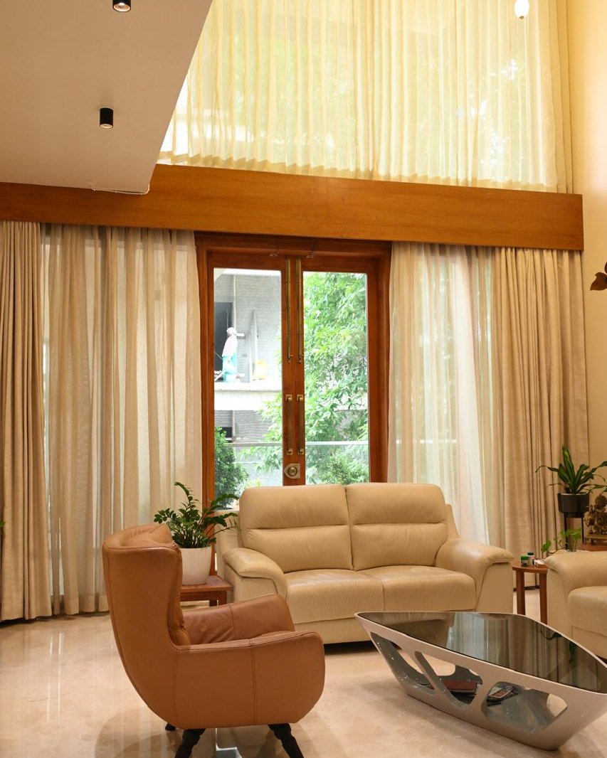 Completed living room with layered seating and full-height curtains